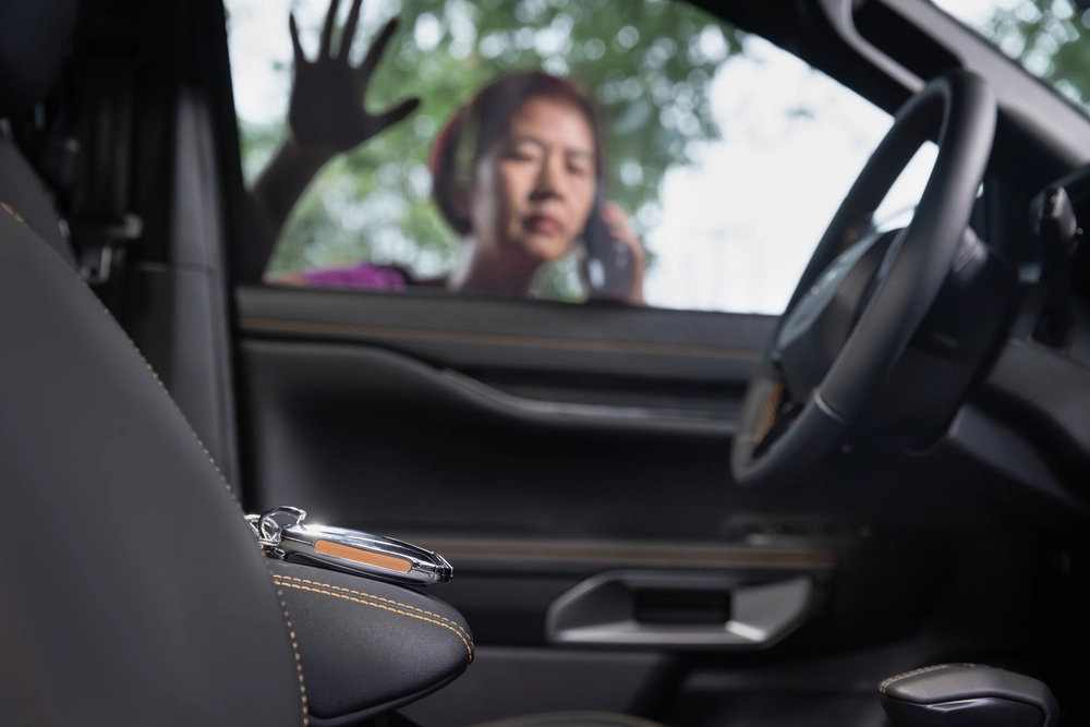 asian woman calling for help after locking keys in car
