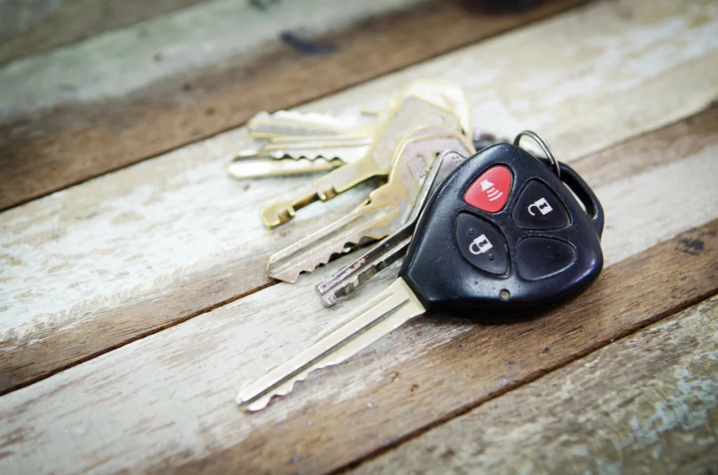 close up of car keys on wood background